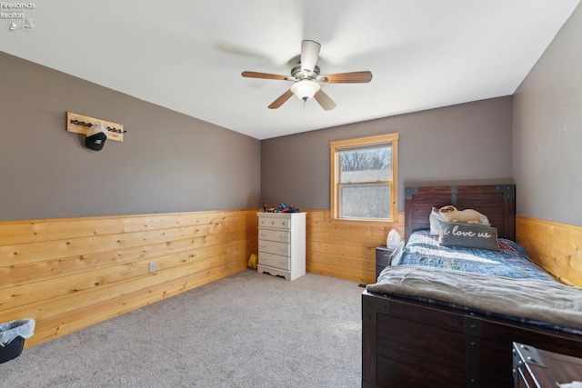 3769 Prospect Rd, New London, OH 44851 - bedroom with wood walls, a ceiling fan, a wainscoted wall, and carpet floors
