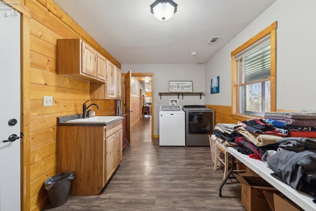3769 Prospect Rd, New London, OH 44851 - kitchen with visible vents, separate washer and dryer, a sink, dark wood-style floors, and wooden walls