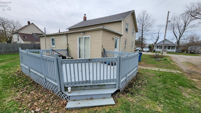 3510 Ohio St, Sandusky, OH 44870 - rear view of property featuring fence, a yard, a wooden deck, and a chimney