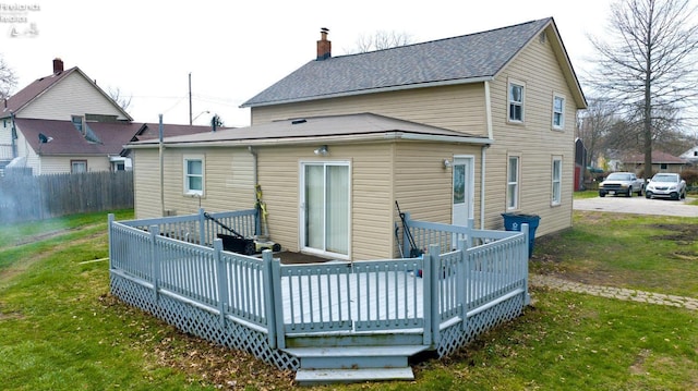3510 Ohio St, Sandusky, OH 44870 - rear view of house featuring a shingled roof, a wooden deck, a chimney, and a lawn