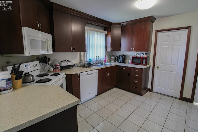 3510 Ohio St, Sandusky, OH 44870 - kitchen with white appliances, light countertops, a sink, and dark brown cabinetry