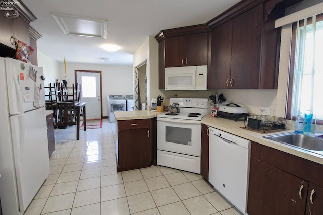 3510 Ohio St, Sandusky, OH 44870 - kitchen featuring white appliances, light countertops, washing machine and clothes dryer, and a healthy amount of sunlight