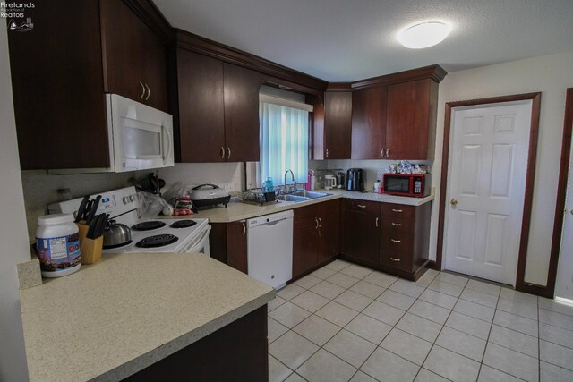 3510 Ohio St, Sandusky, OH 44870 - kitchen featuring white appliances, light countertops, a sink, and dark brown cabinets