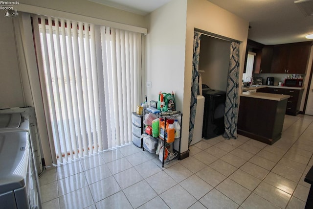 3510 Ohio St, Sandusky, OH 44870 - kitchen with washer / clothes dryer, light tile patterned floors, light countertops, and a peninsula