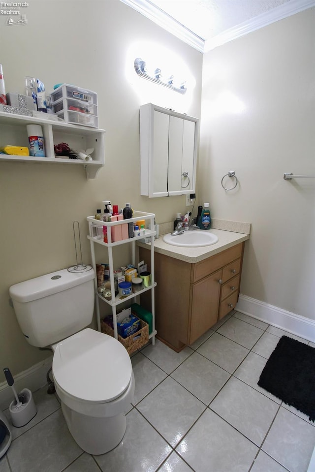 3510 Ohio St, Sandusky, OH 44870 - bathroom with baseboards, toilet, crown molding, vanity, and tile patterned flooring