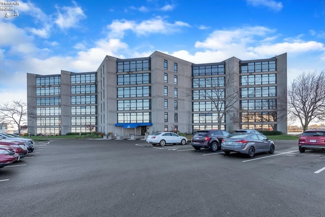 view of building exterior with uncovered parking
