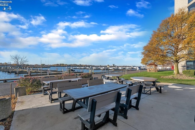 view of patio / terrace featuring outdoor dining space, a dock, and a water view
