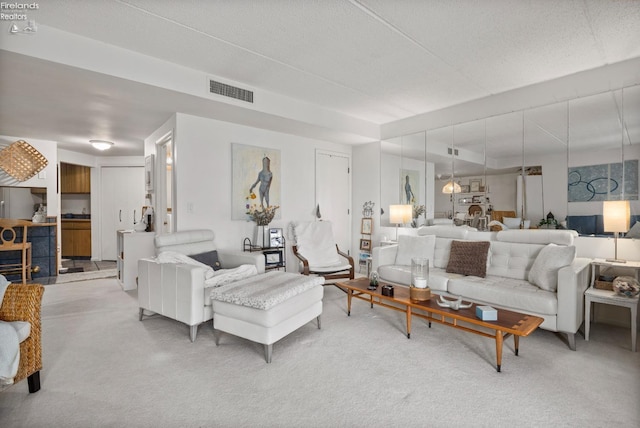 living room with carpet and visible vents