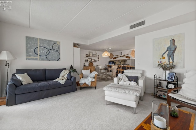living room featuring visible vents and carpet flooring