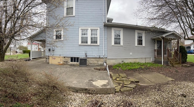back of property with central AC