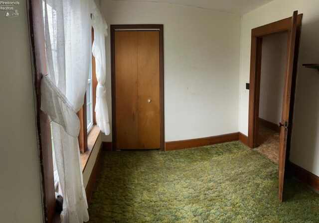 bedroom featuring a closet, baseboards, and carpet floors