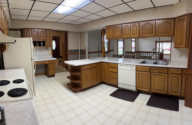 kitchen with open shelves, a sink, light countertops, white appliances, and light floors