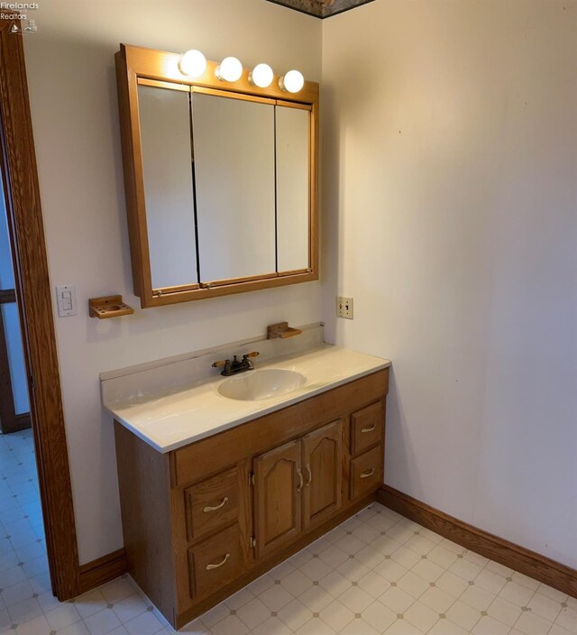 bathroom featuring tile patterned floors, vanity, and baseboards