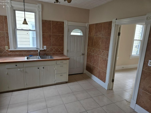 430 Perry St, Sandusky, OH 44870 - kitchen featuring plenty of natural light, light tile patterned floors, light countertops, and a sink