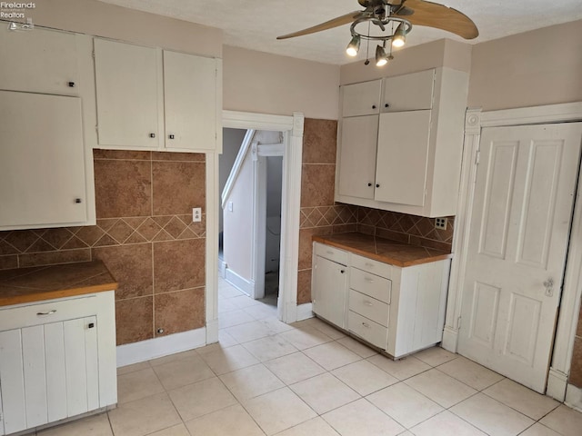 430 Perry St, Sandusky, OH 44870 - kitchen with tasteful backsplash, light tile patterned floors, dark countertops, and a ceiling fan