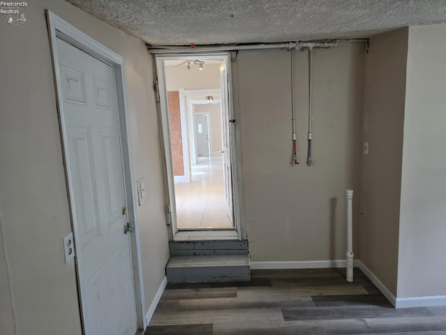 430 Perry St, Sandusky, OH 44870 - hall featuring a textured ceiling, baseboards, and wood finished floors