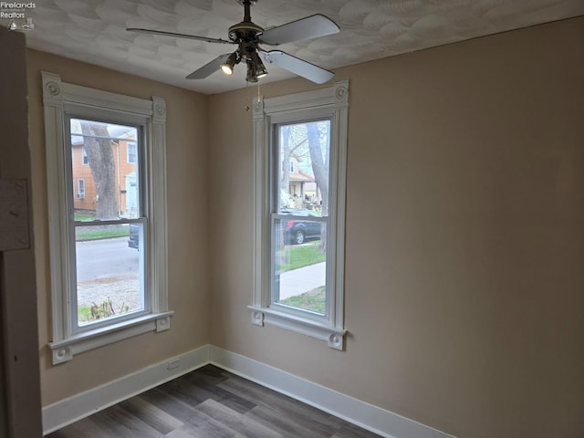 430 Perry St, Sandusky, OH 44870 - empty room featuring a wealth of natural light, ceiling fan, baseboards, and dark wood finished floors