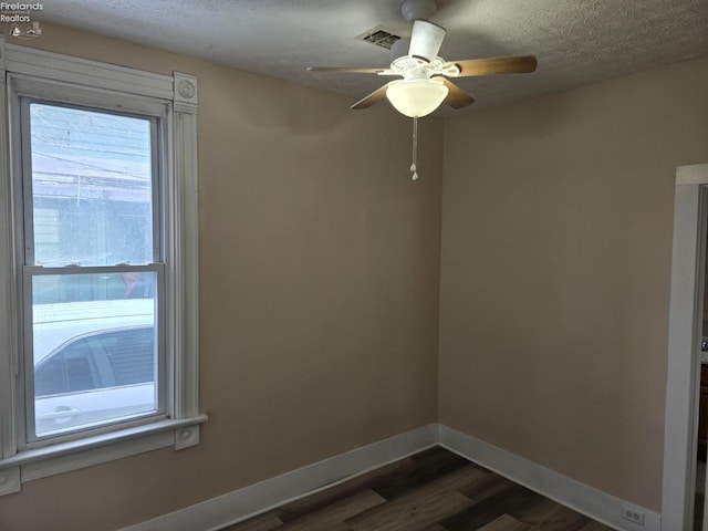 430 Perry St, Sandusky, OH 44870 - empty room featuring visible vents, a wealth of natural light, baseboards, and dark wood-style floors