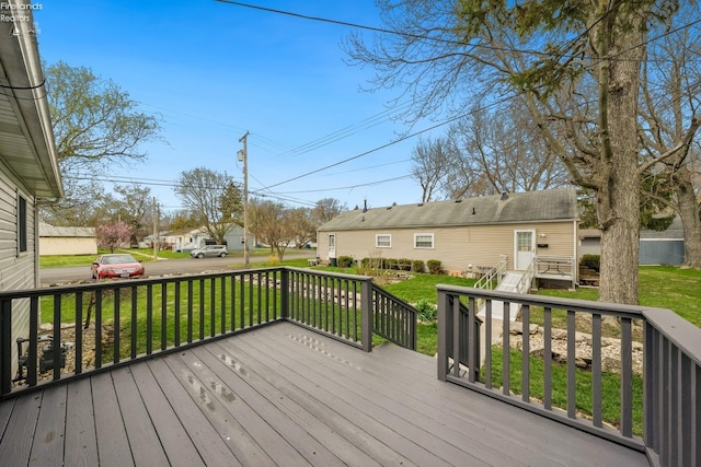 deck with a residential view and a lawn