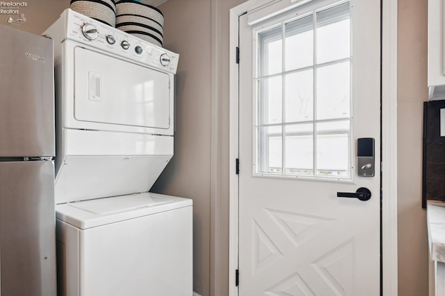 laundry area with stacked washer / dryer and laundry area