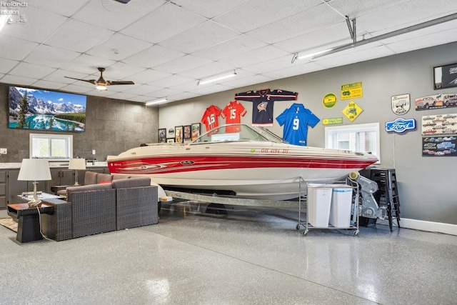 garage featuring ceiling fan and baseboards