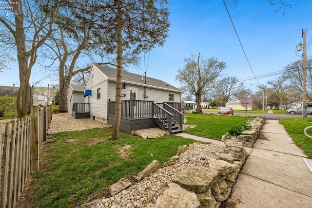 view of yard featuring a wooden deck and fence