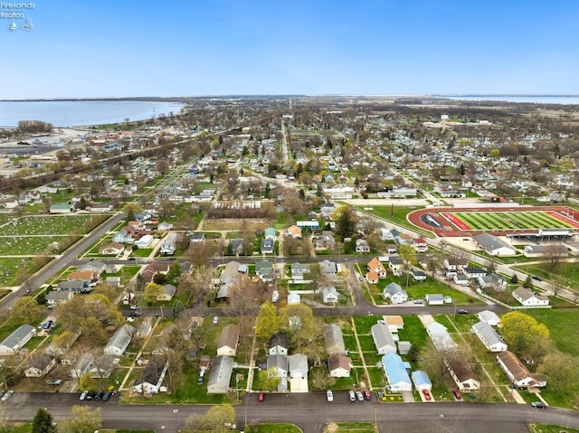 birds eye view of property with a water view and a residential view