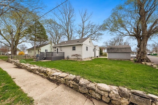 exterior space with a yard, a storage shed, an outdoor structure, and a wooden deck