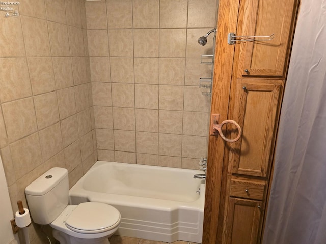 bathroom featuring bathtub / shower combination and toilet