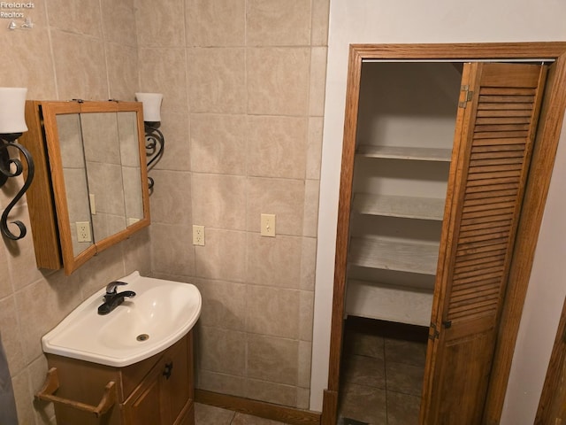 bathroom with tile walls and vanity