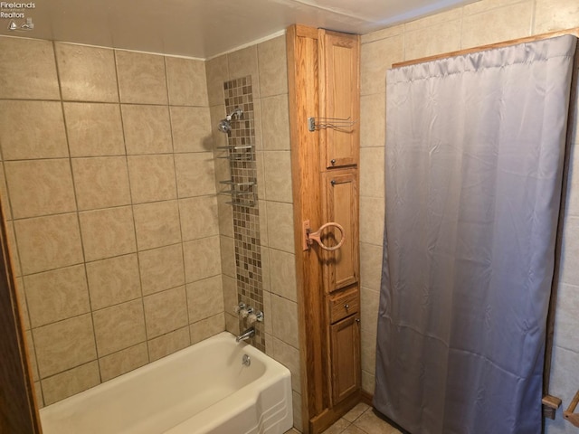 full bath featuring tile patterned floors and shower / bath combo with shower curtain