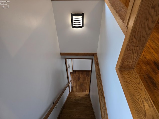 stairs featuring wood finished floors