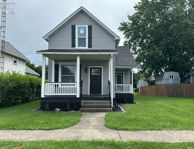 921 White Ave, Fremont, OH 43420 - bungalow-style house with a porch, fence, a shingled roof, and a front yard