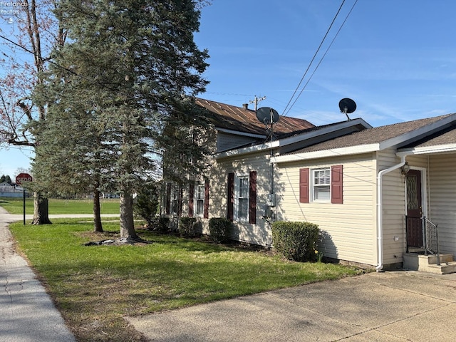 view of side of home featuring a yard