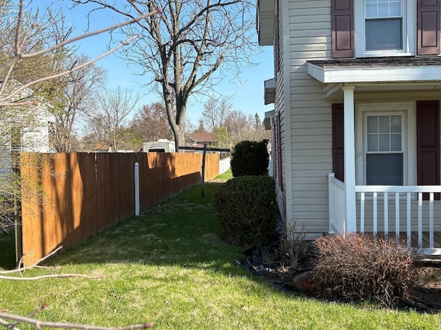 view of property exterior with fence and a yard