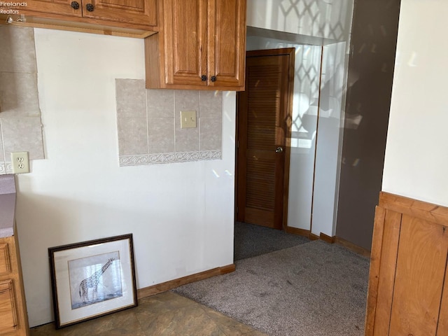 kitchen featuring brown cabinets and decorative backsplash