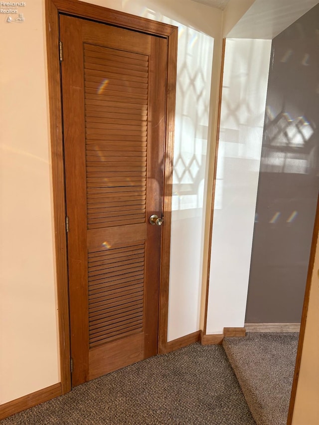 interior space with baseboards and carpet