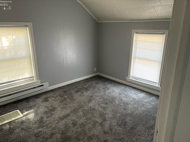 unfurnished room with a baseboard heating unit, baseboards, visible vents, dark carpet, and ornamental molding