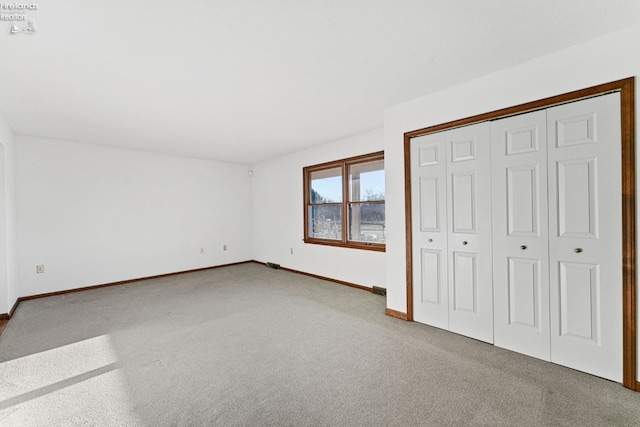 1001 Birchwood Dr, Sandusky, OH 44870 - unfurnished bedroom with baseboards, carpet floors, and a closet