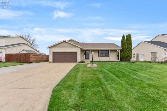 1001 Birchwood Dr, Sandusky, OH 44870 - ranch-style home with a garage, driveway, a front yard, and fence