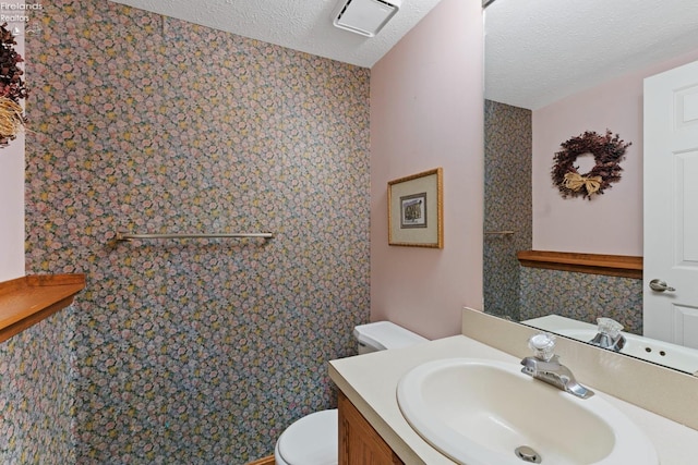 1001 Birchwood Dr, Sandusky, OH 44870 - half bath with toilet, vanity, a textured ceiling, and visible vents