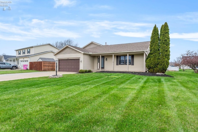 1001 Birchwood Dr, Sandusky, OH 44870 - ranch-style house featuring an attached garage, a porch, a front yard, and concrete driveway