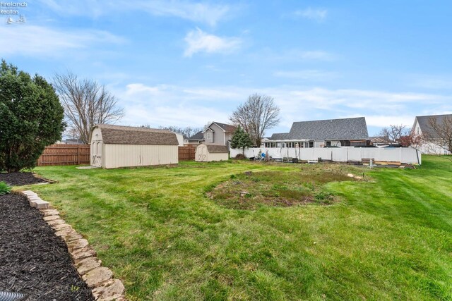 1001 Birchwood Dr, Sandusky, OH 44870 - view of yard featuring an outdoor structure, a storage unit, and a fenced backyard