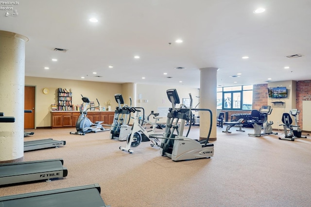 exercise room featuring recessed lighting, carpet flooring, visible vents, and decorative columns