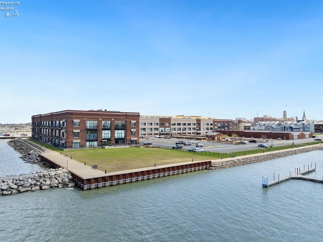 exterior space featuring a lawn and a water view
