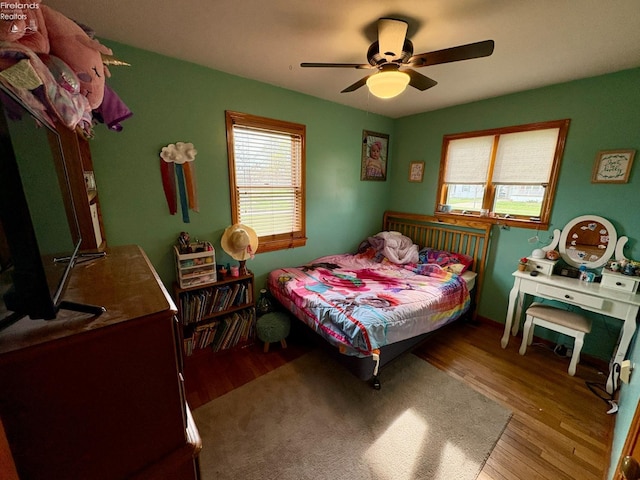 bedroom featuring wood finished floors and ceiling fan