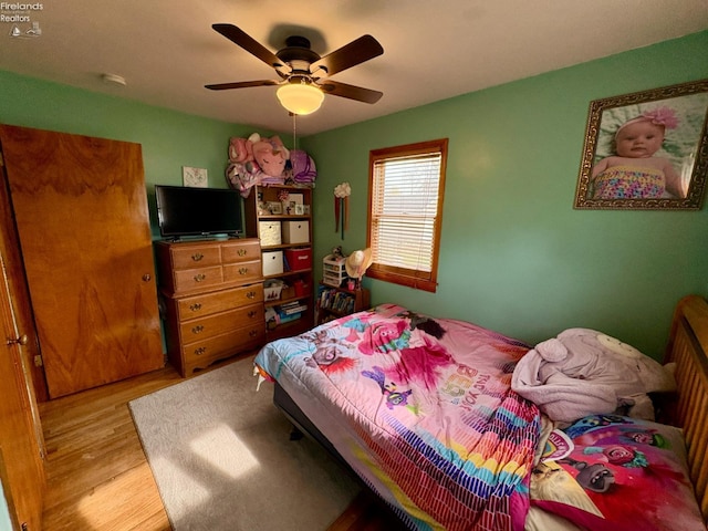 bedroom featuring wood finished floors and ceiling fan