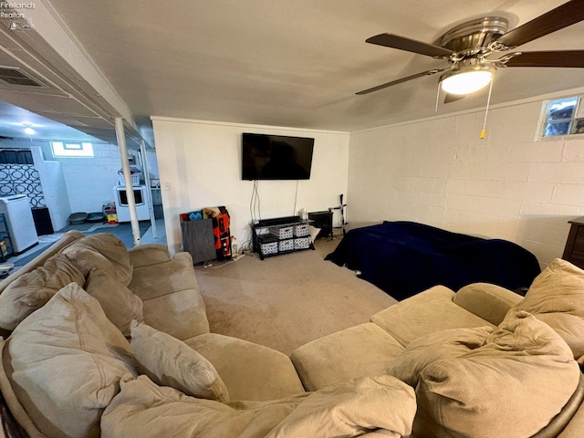 carpeted living room with concrete block wall, a ceiling fan, and visible vents