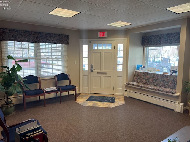 entryway featuring a paneled ceiling, a wealth of natural light, carpet flooring, and baseboard heating