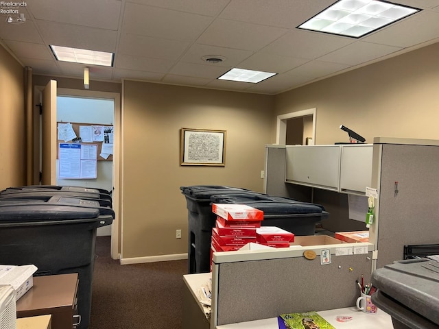 misc room featuring dark colored carpet, visible vents, a drop ceiling, and baseboards